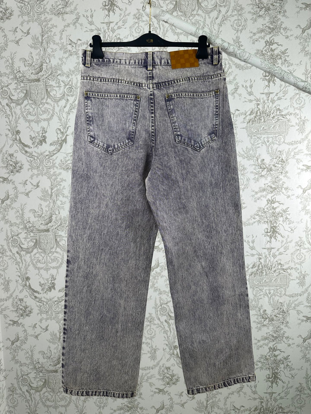 Light wash denim jeans with straight legs, button fly, and front pockets