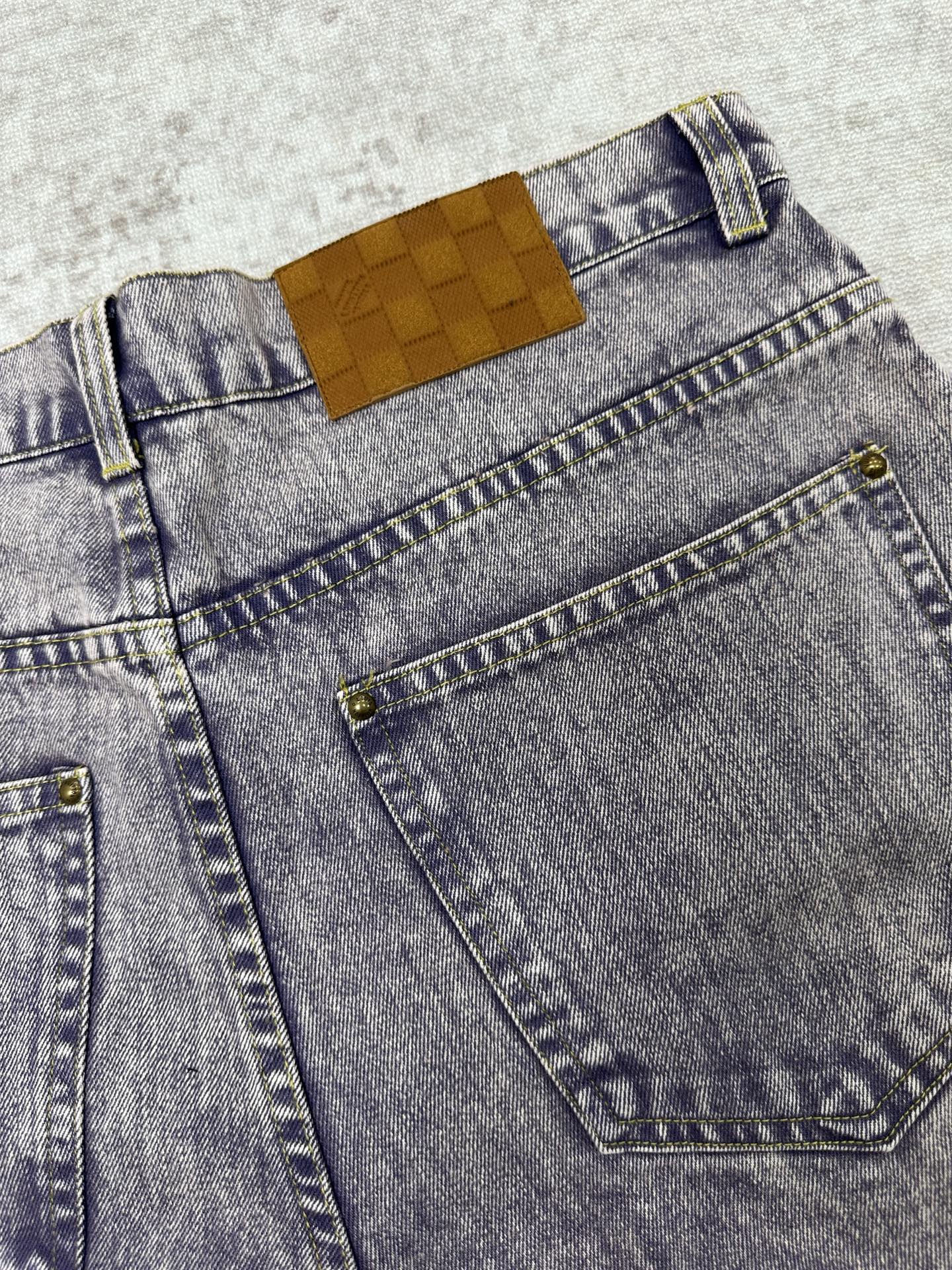 Light blue denim front pocket with orange Louis Vuitton logo patch