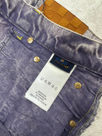 Denim jeans interior label with sizing tag and gold button hardware