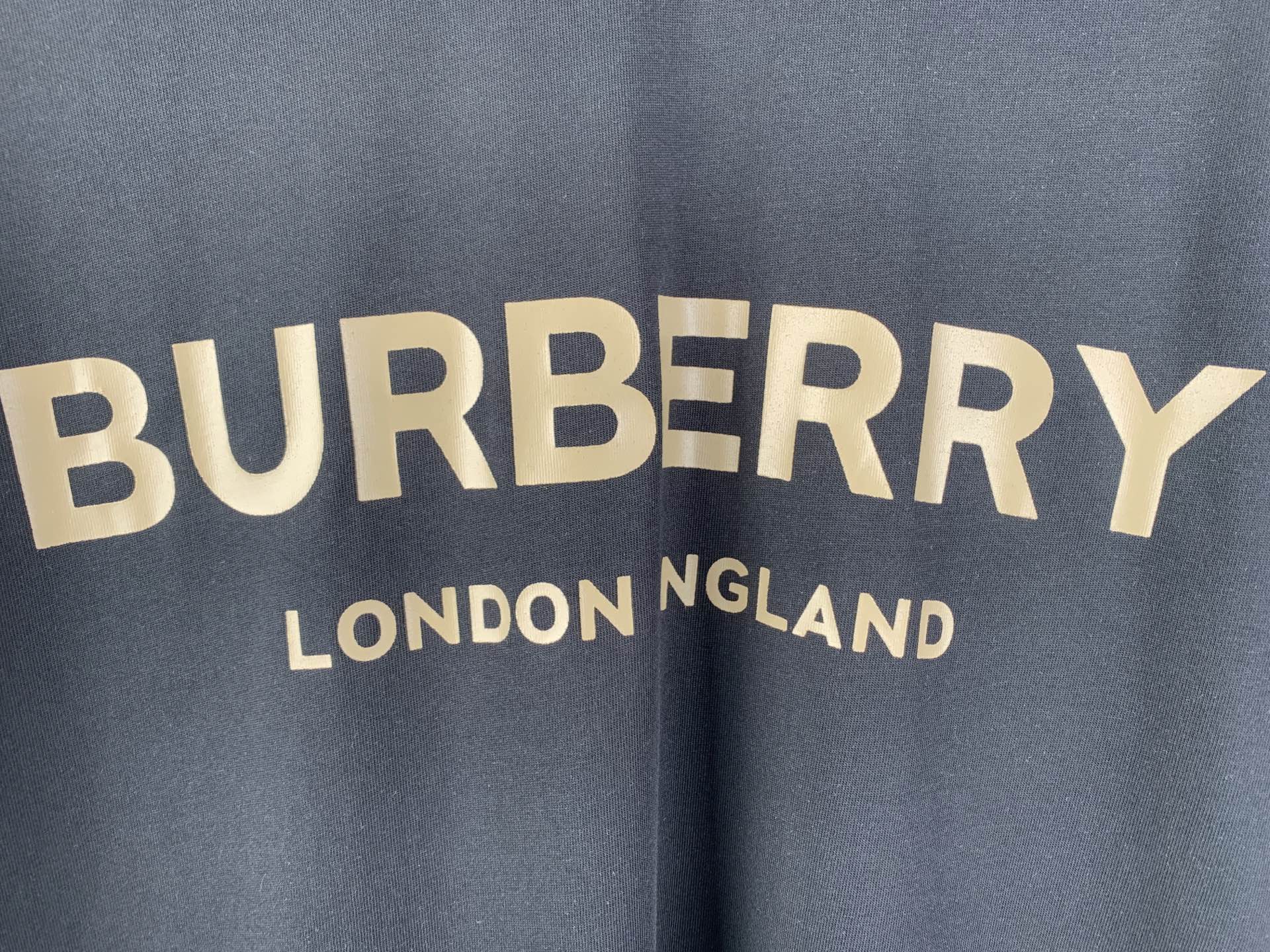 Navy T-shirt with “BURBERRY” and “LONDON ENGLAND” text graphic