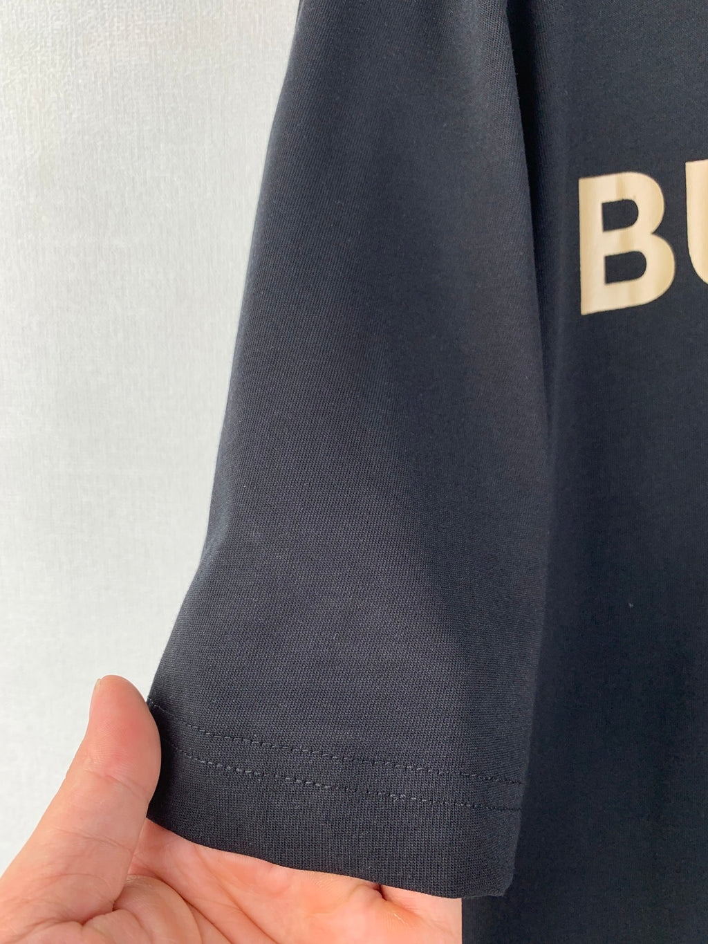 Navy T-shirt sleeve hem with double-stitched seam