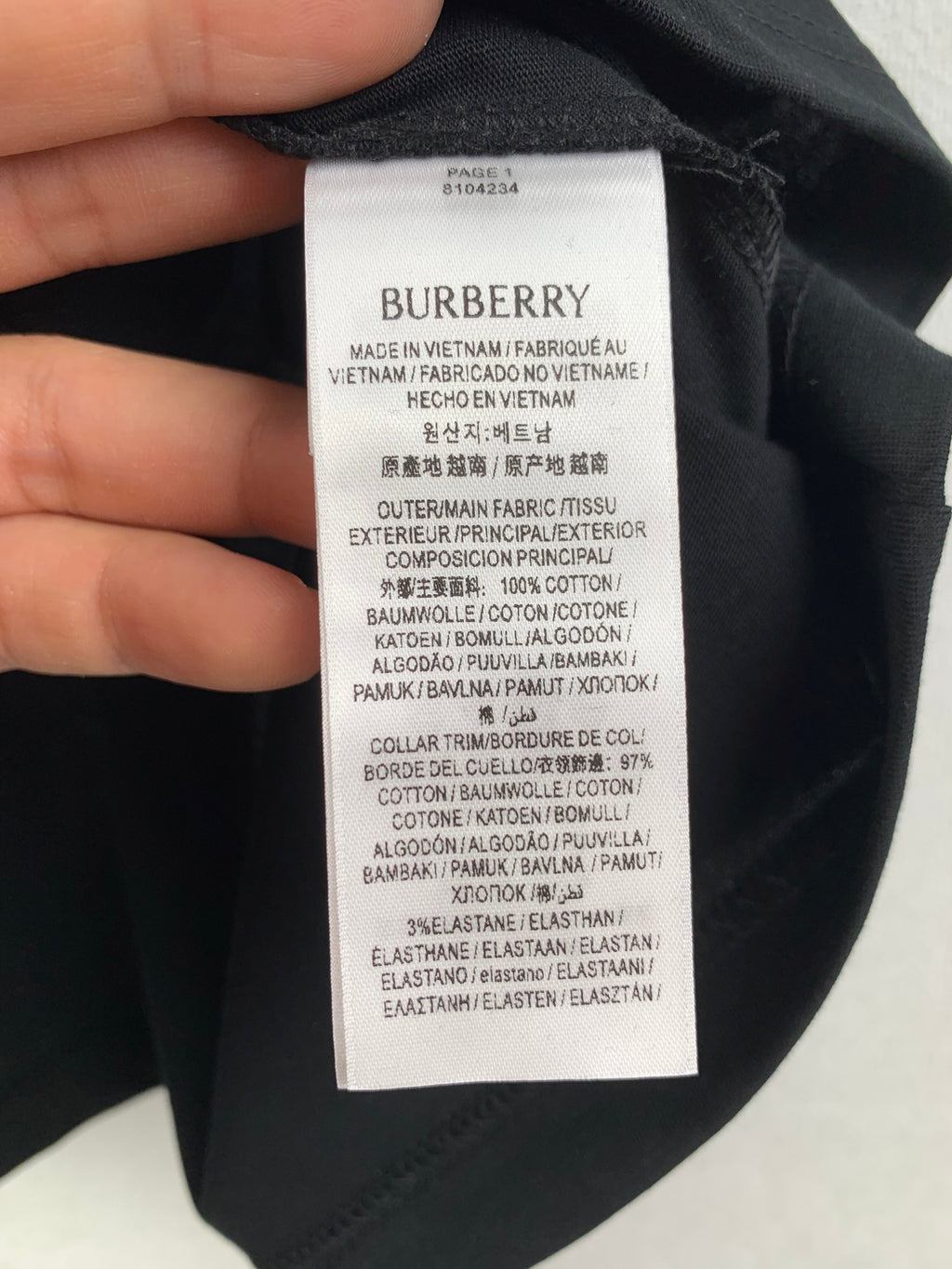 Navy T-shirt inside neck label with Burberry branding and care instructions