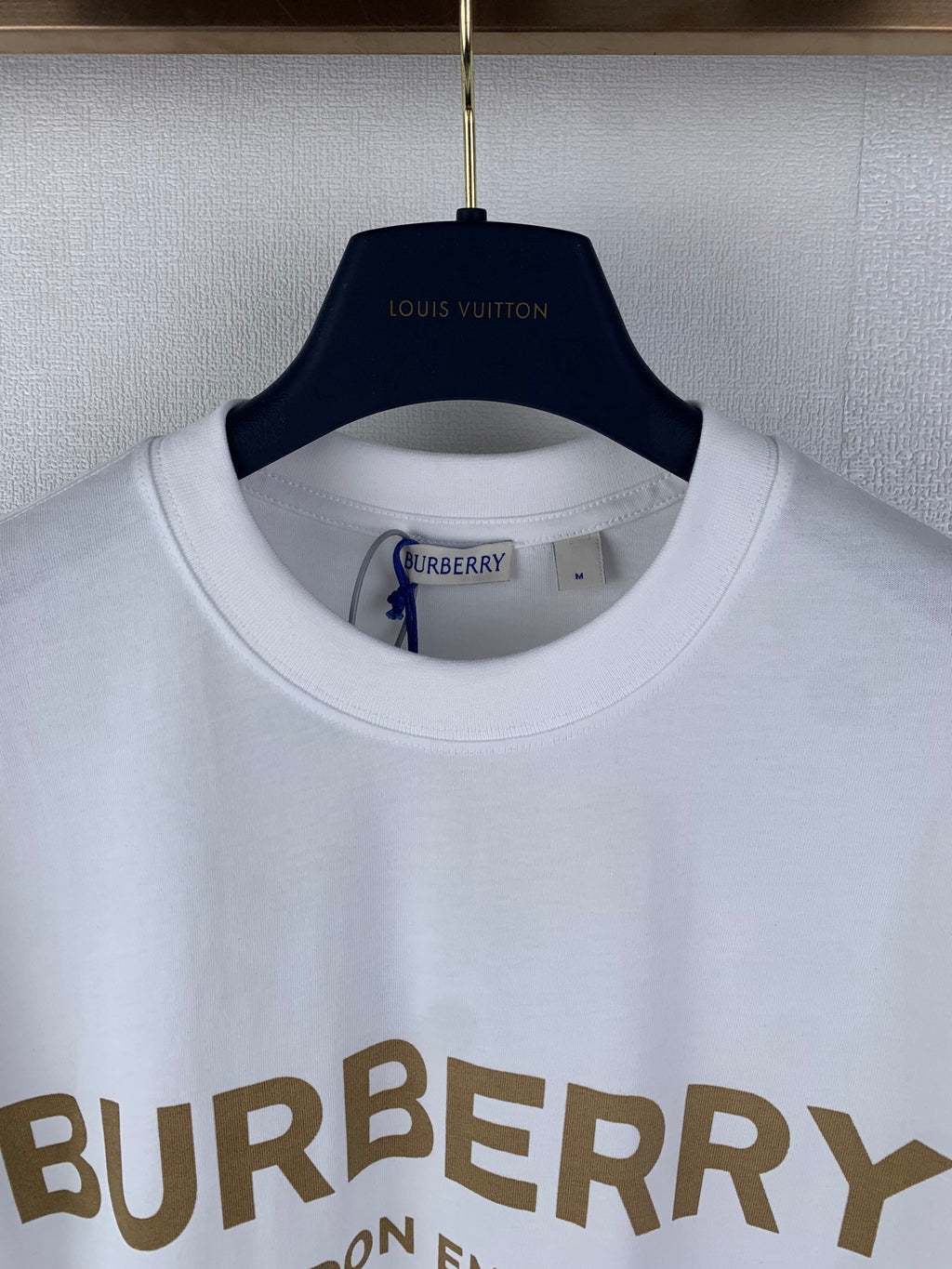 White Burberry crew-neck T-shirt collar with partial BURBERRY lettering