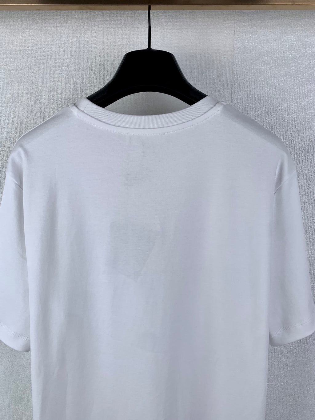 White short-sleeve T-shirt, back view close-up