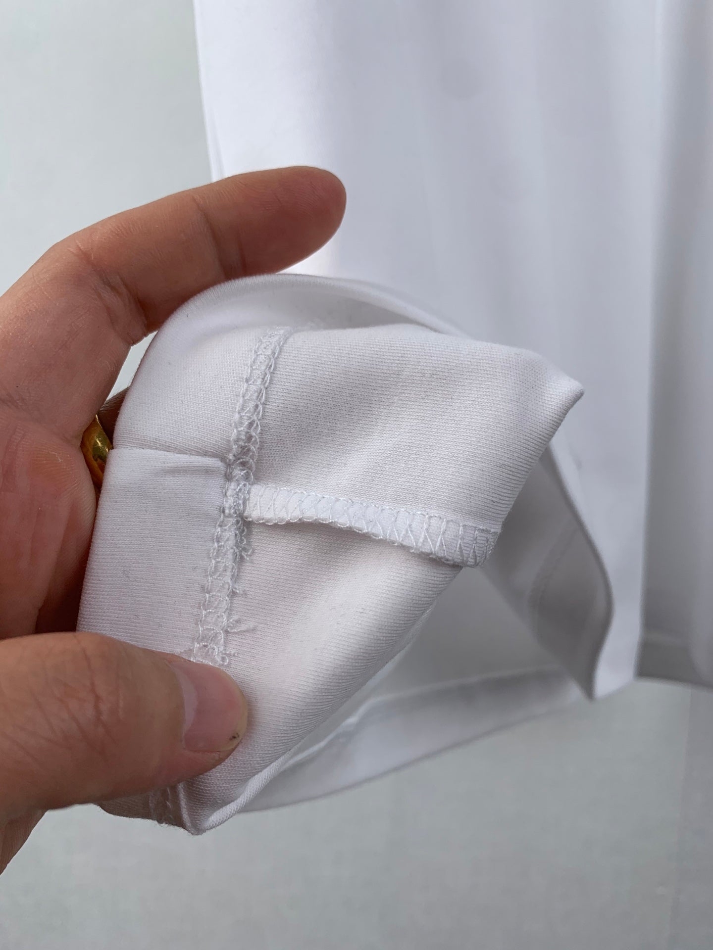 White T-shirt cuff with seam detail