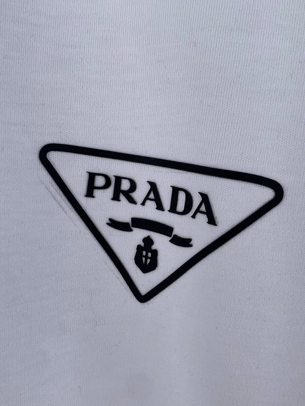 Prada triangle logo patch on white T-shirt