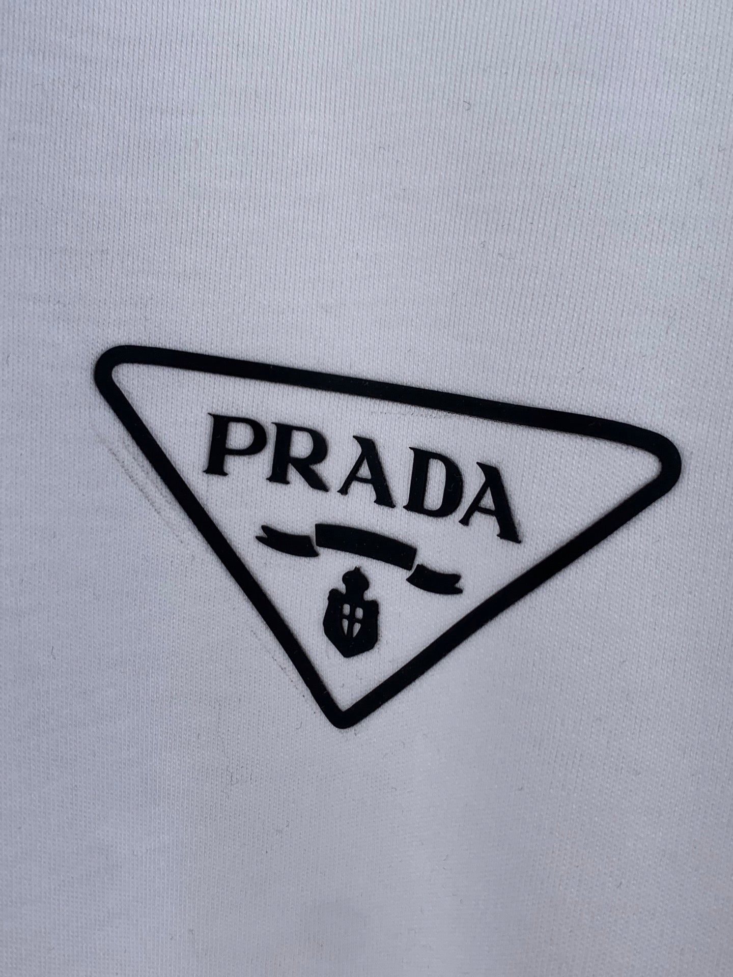 Prada triangle logo patch on white T-shirt