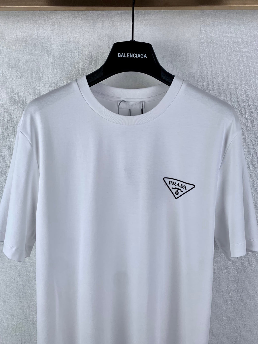 White short-sleeve T-shirt with small Prada triangle logo on chest