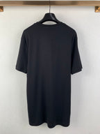 Back view of dark T-shirt with short sleeves and crew neckline.