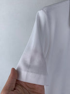 White polo fabric texture close-up, short sleeve