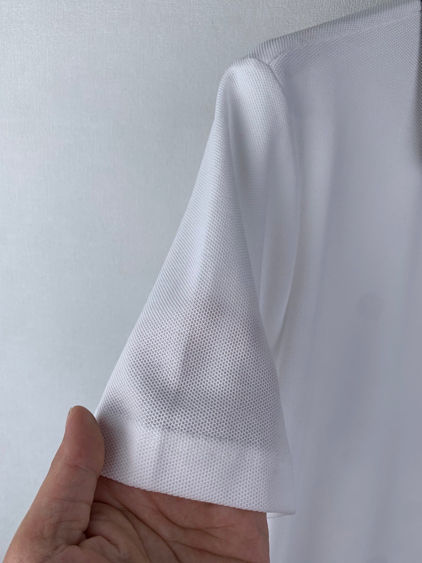 White polo fabric texture close-up, short sleeve