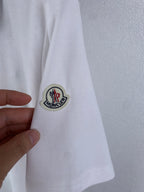 White polo sleeve with round Moncler crest patch