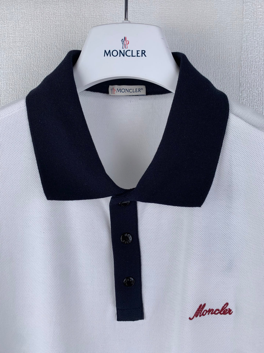 White polo shirt with black collar and front buttons, Moncler badge