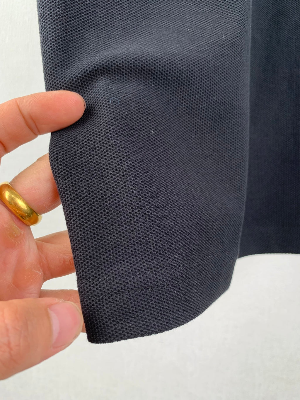 Moncler polo shirt fabric close-up with subtle mesh-like texture