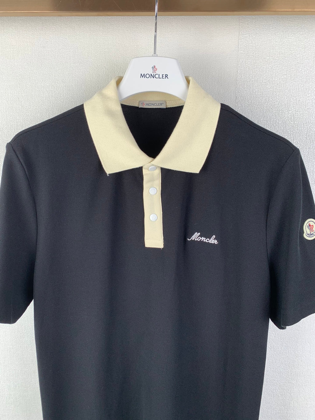 Moncler polo shirt with cream collar, button placket, and chest logo