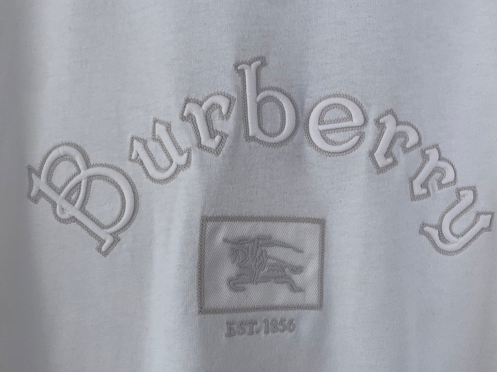 White T-shirt close-up of Burberry wordmark and crest graphic