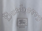 White T-shirt close-up of Burberry wordmark and crest graphic