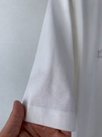 White T-shirt sleeve cuff and hem stitching, close-up