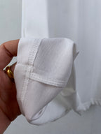 White T-shirt cuff area with stitched hem and seam