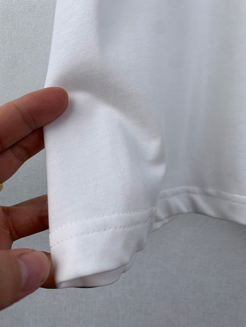 White T-shirt side seam and lower hem with stitched edge