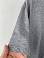 Gray T-shirt sleeve and hem detail, knit fabric.