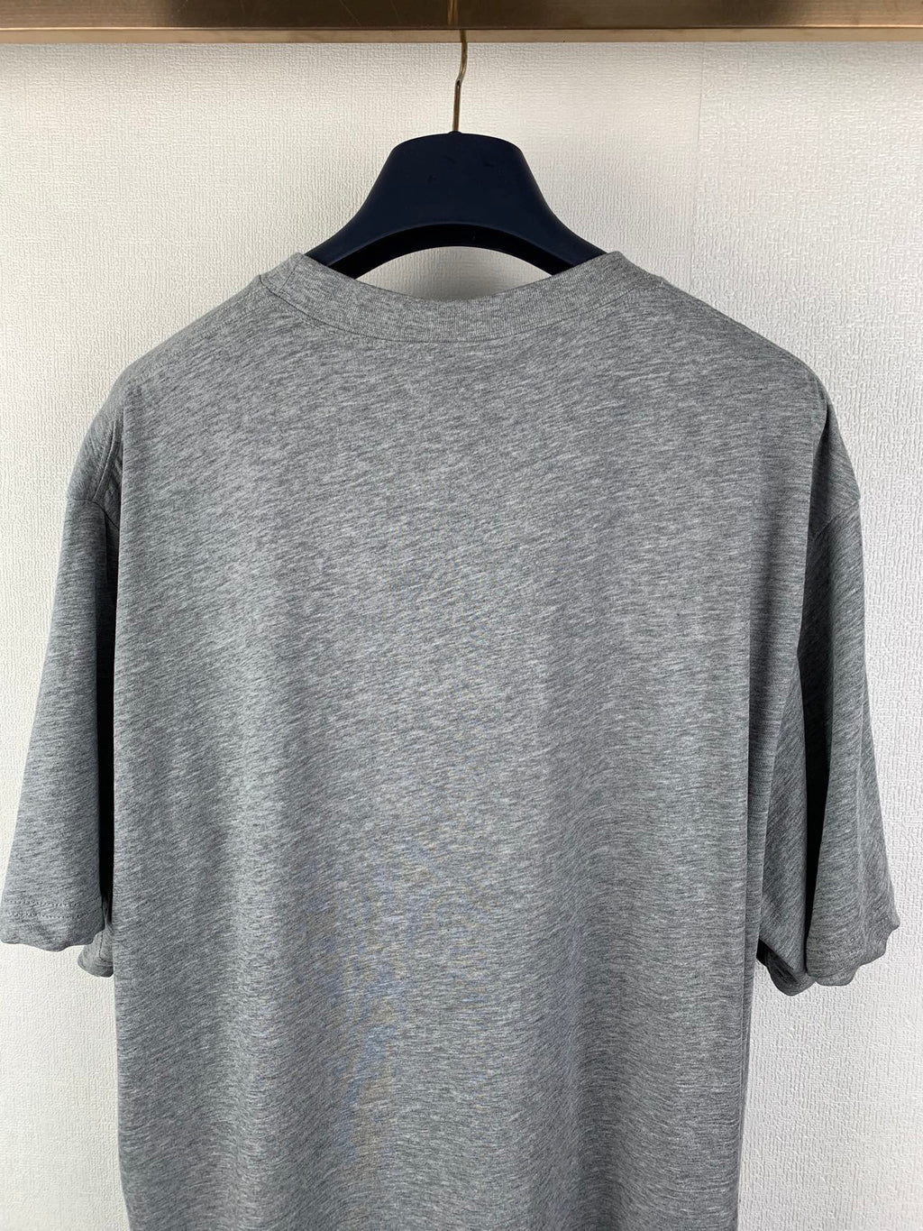 Gray short-sleeve T-shirt back view, crew neckline detail.