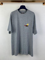 Gray short-sleeve T-shirt with small illustrated chest graphic, crew neck.