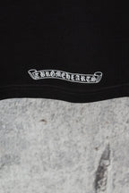 Chrome short T-shirt hem, close-up of white arched text logo near the bottom seam