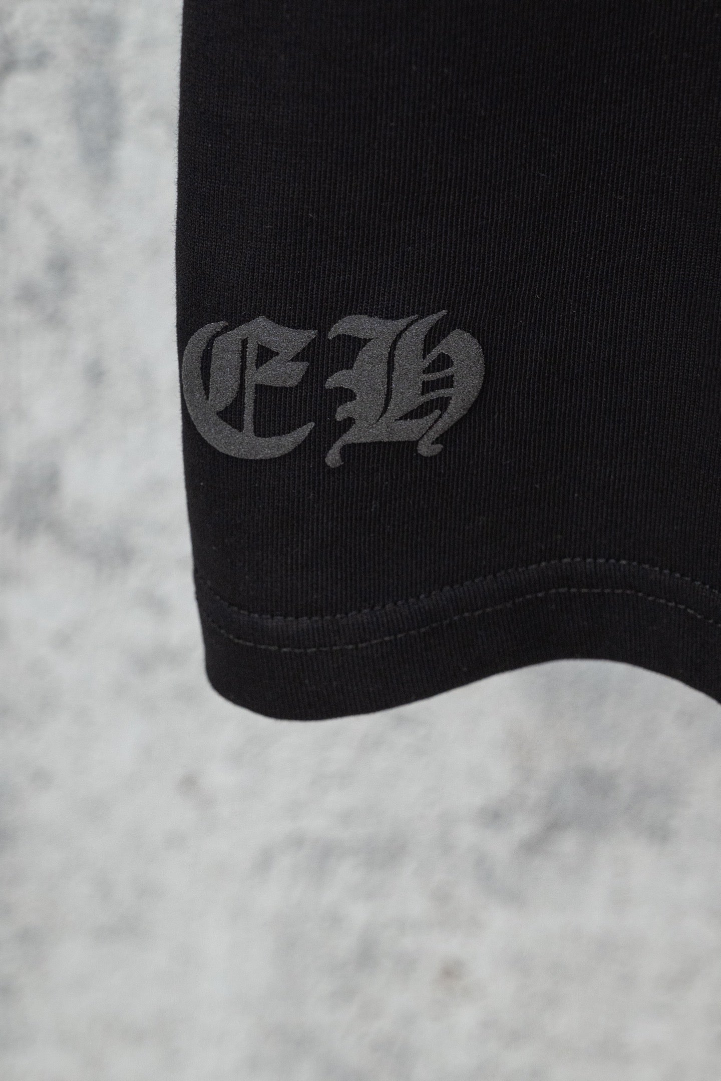 Chrome short T-shirt hem cuff, black with small gray text logo