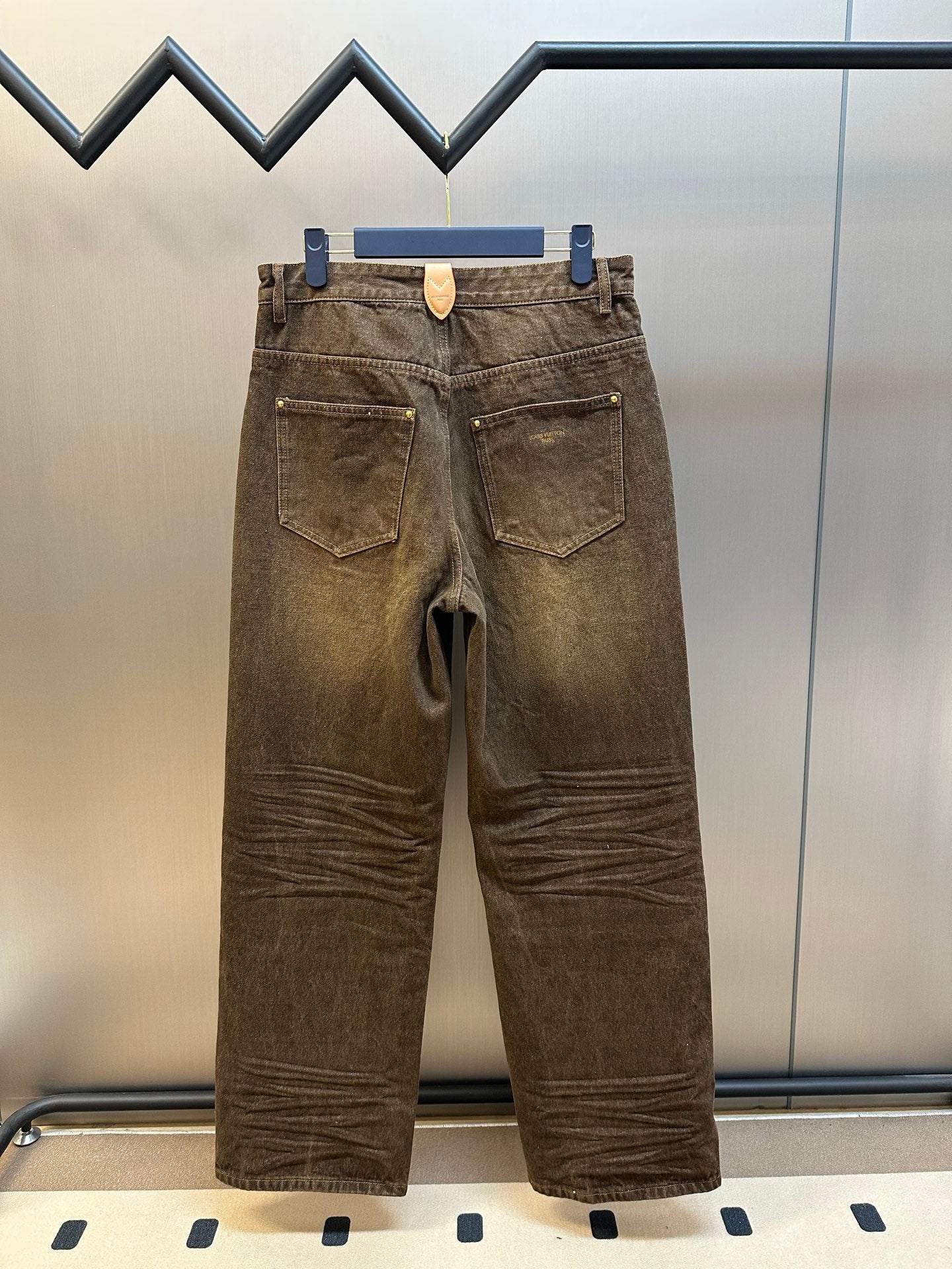 Brown denim jeans with two back patch pockets and belt loops