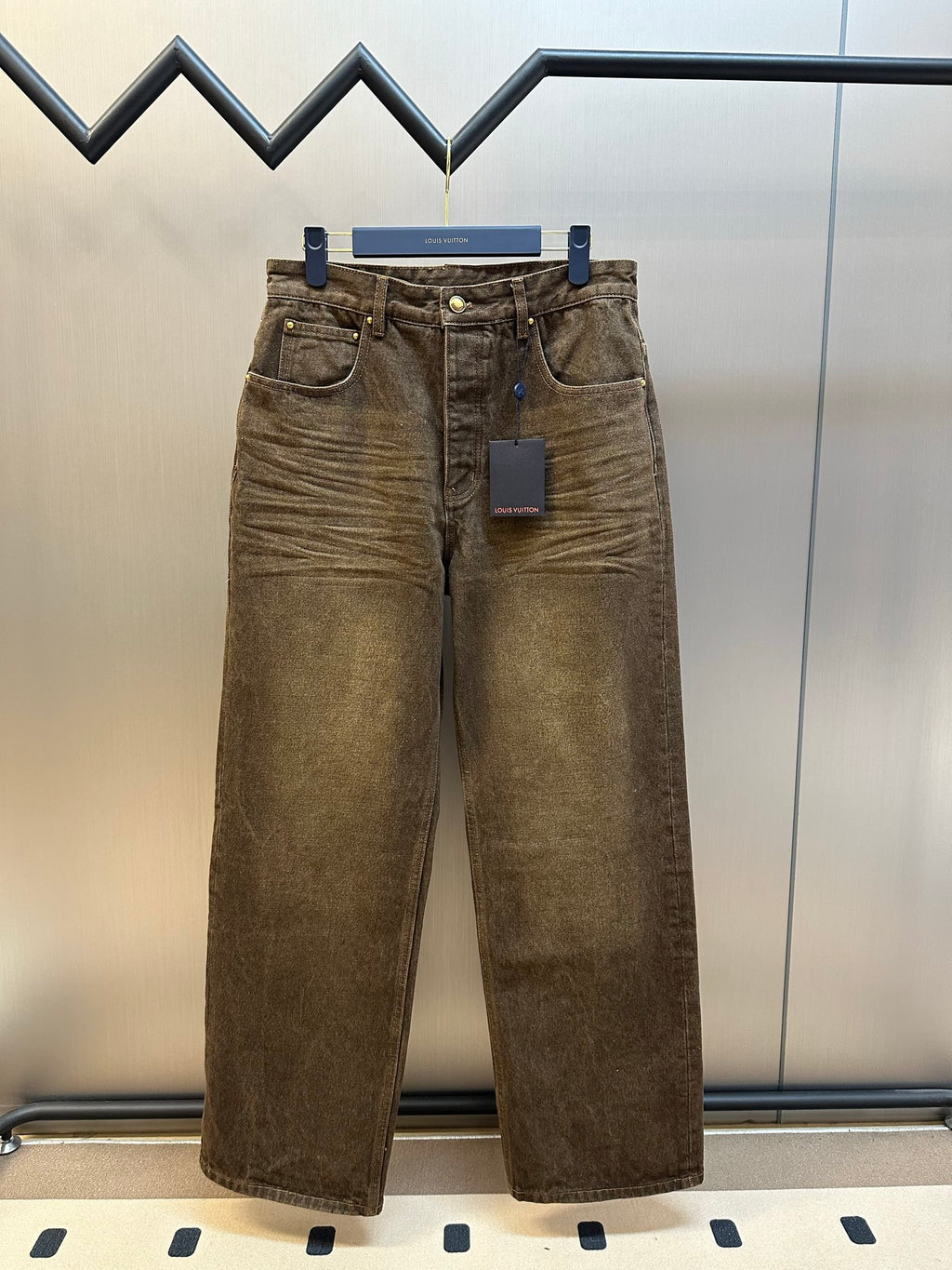 Brown denim jeans with front button and belt loops