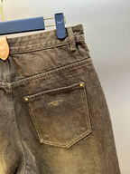 Brown denim jeans close-up, front pocket with Louis Vuitton label