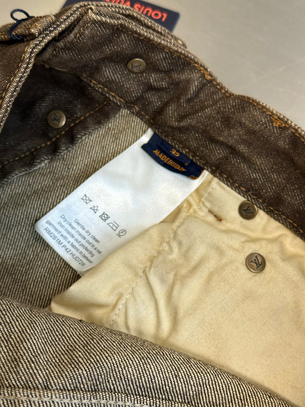 Brown denim jeans, inside waistband with Louis Vuitton Paris size label
