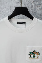 White T-shirt with crew neck, chest pocket, and cartoon graphic