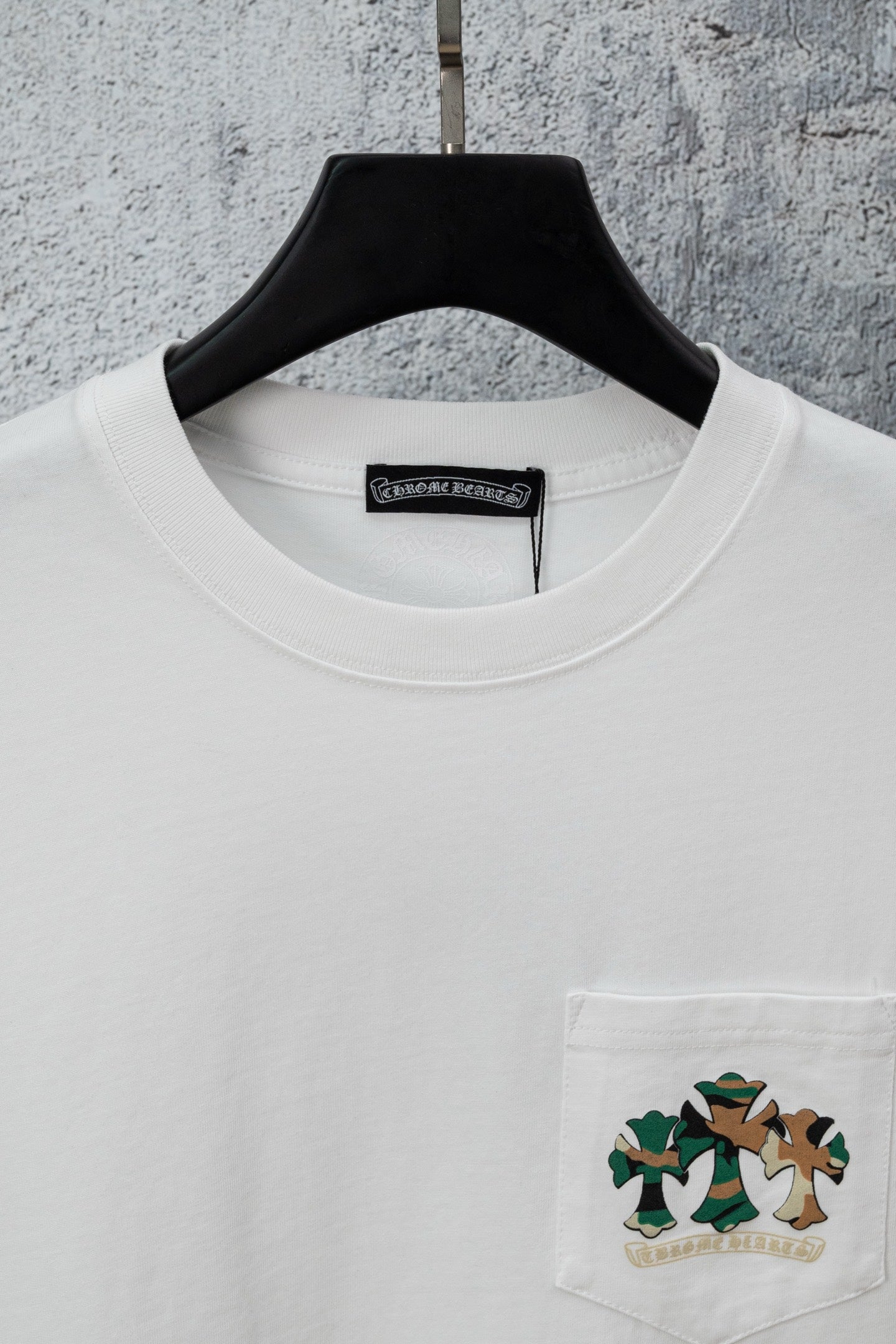 White T-shirt with crew neck, chest pocket, and cartoon graphic