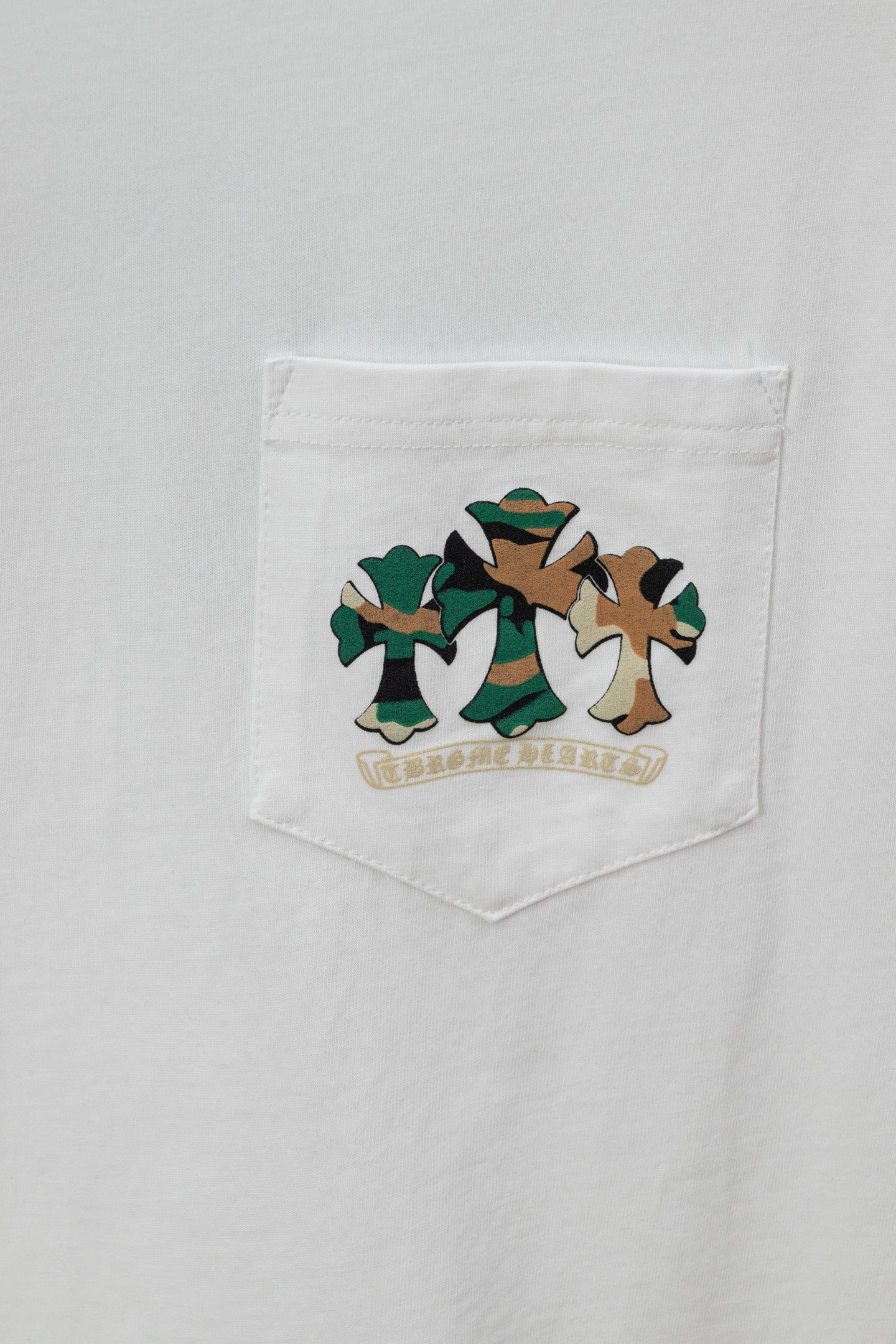 White T-shirt pocket with green and brown cartoon graphic