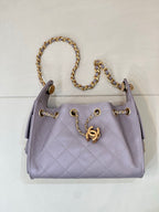Lavender quilted handbag with gold chain top handle and CC logo center front