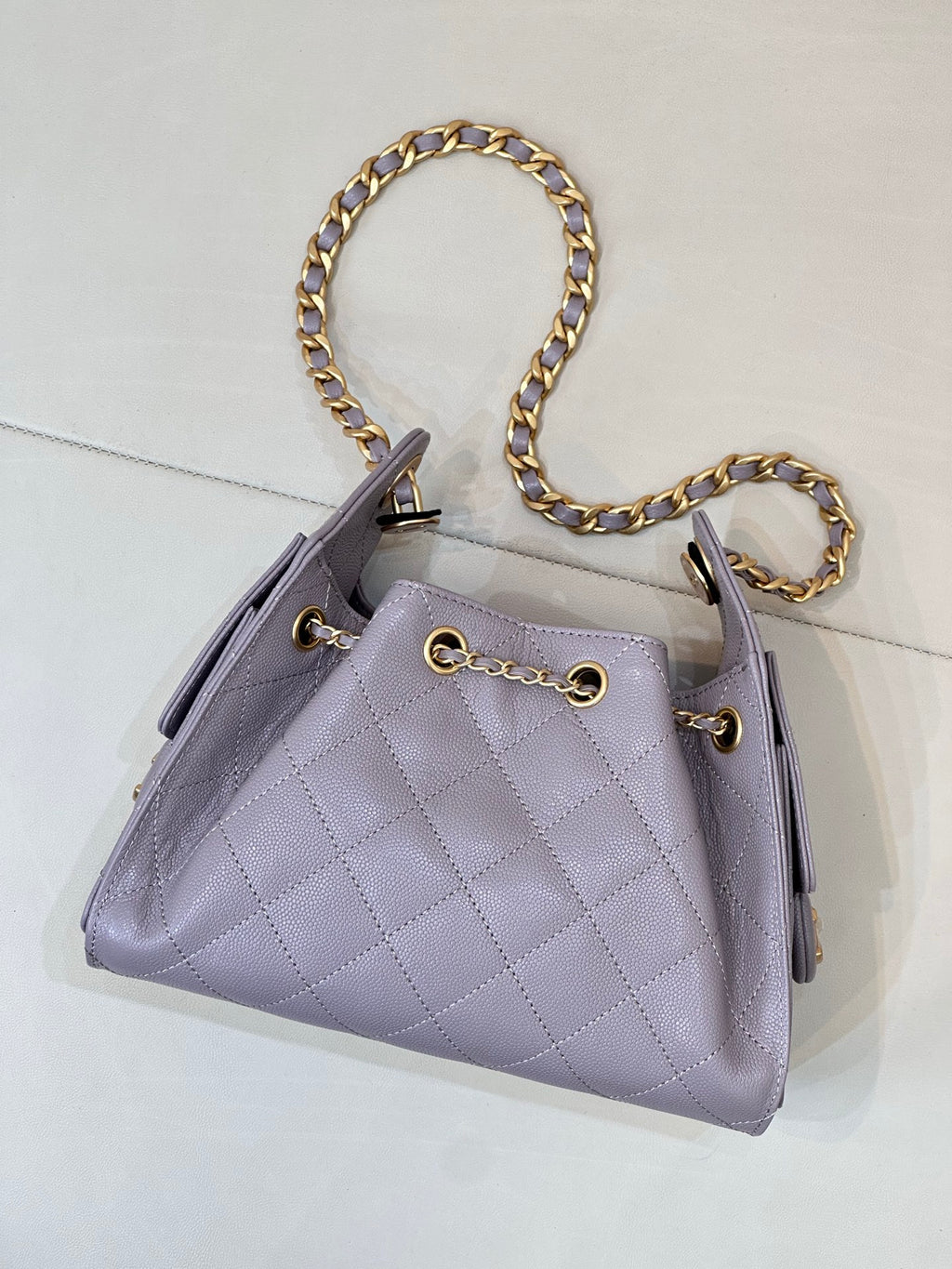 Lavender quilted handbag with gold chain shoulder strap and CC logo front