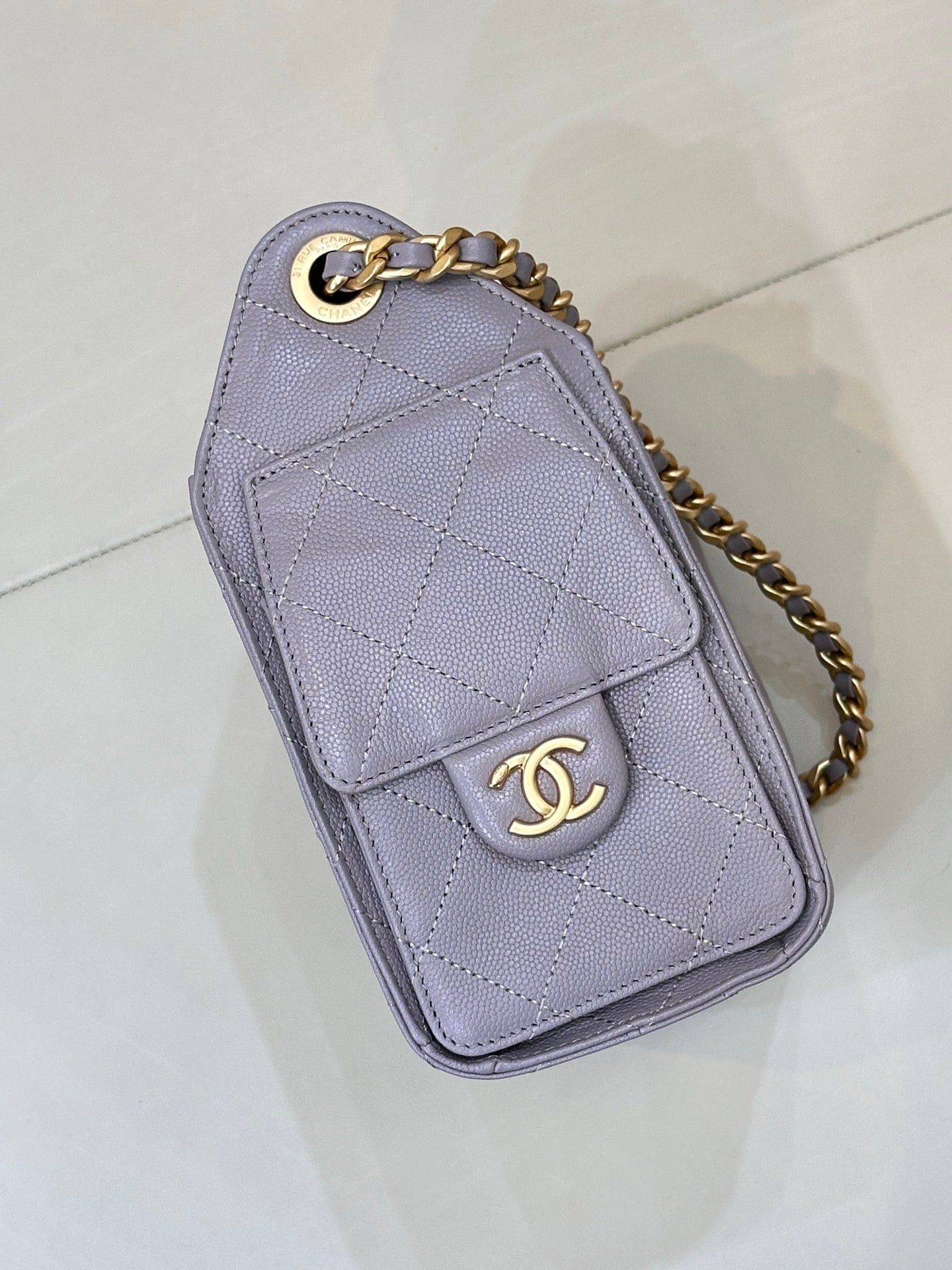 Lavender quilted card case with gold chain strap and CC logo emblem