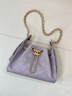 Lavender quilted handbag with gold chain shoulder strap and CC logo on front