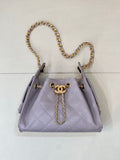 Lavender quilted top-handle bag with gold chain strap and small CC charm clasp