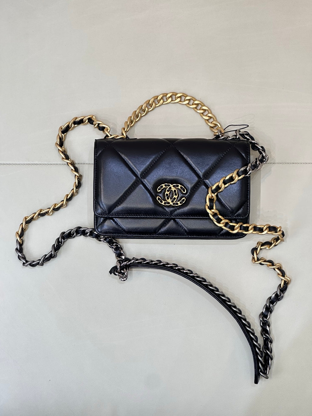 Chanel quilted mini bag with two-tone chain, dark blue flap, and gold CC clasp