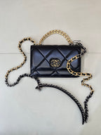 Chanel quilted mini bag with two-tone chain, dark blue flap, and gold CC clasp