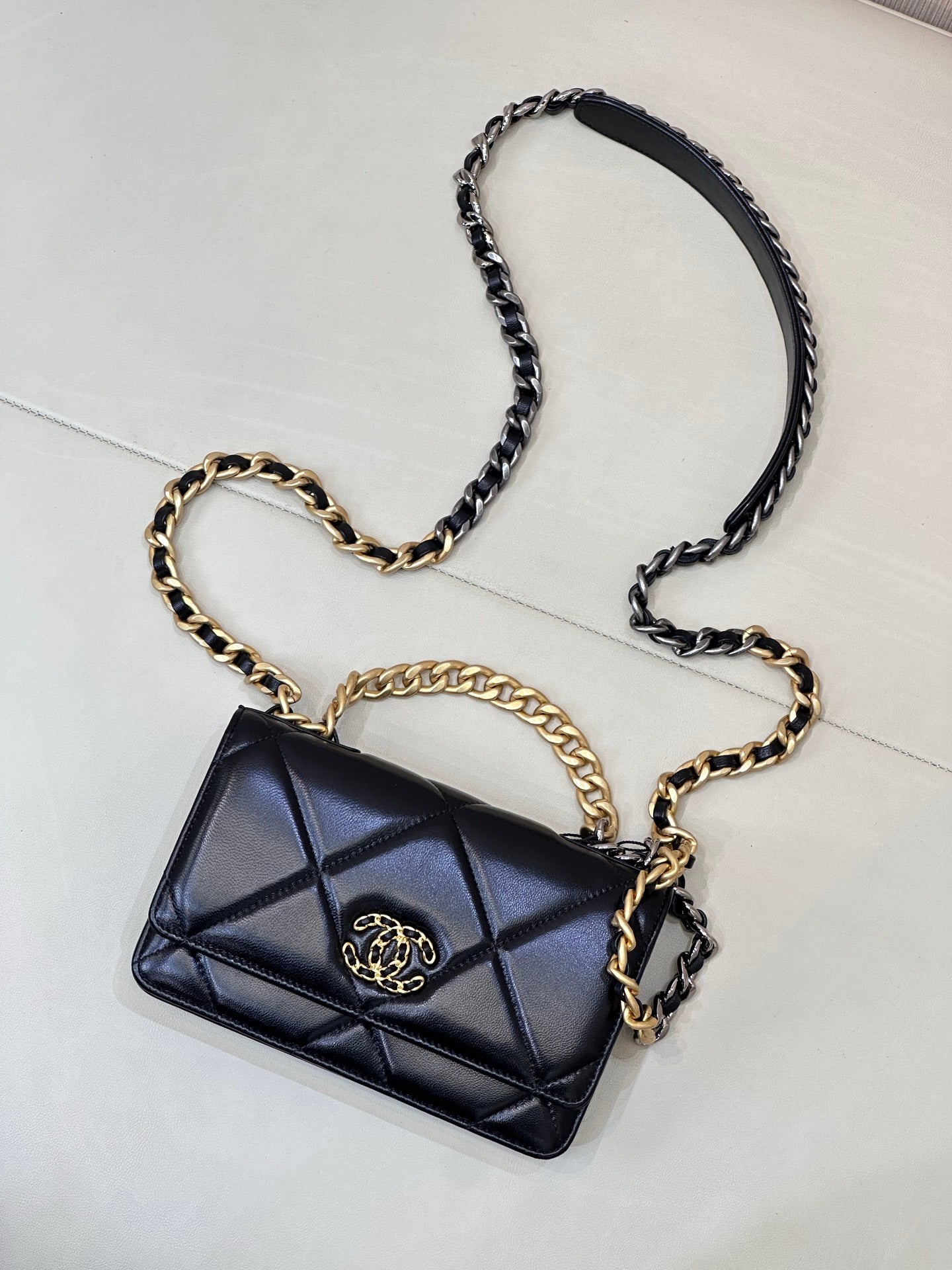 Chanel quilted mini shoulder bag with dark blue flap, CC emblem, and chain crossbody