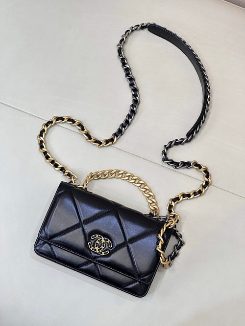 Chanel quilted mini shoulder bag with dark blue flap, CC emblem, and chain crossbody