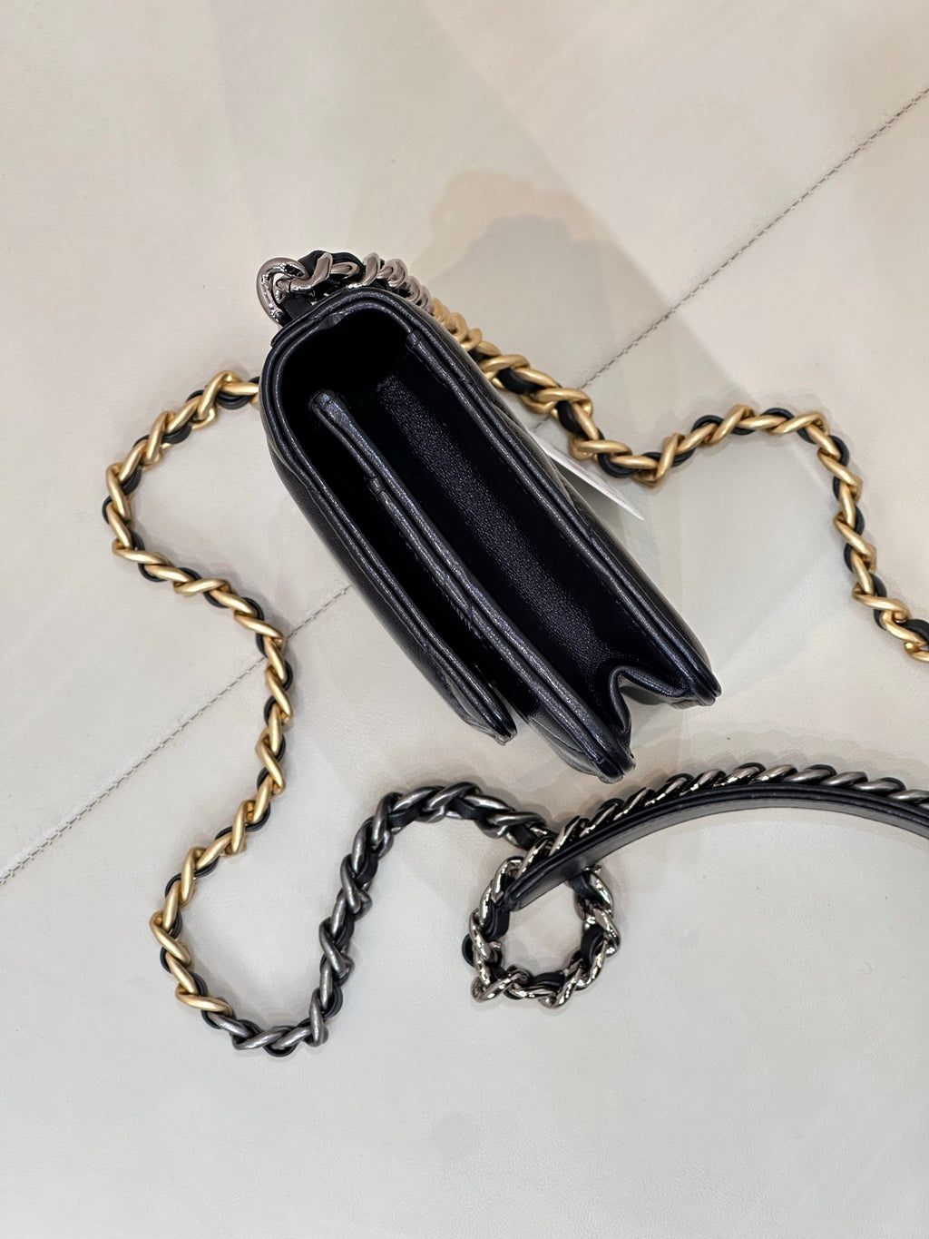 Chanel mini bag back view with dark blue leather, gold and silver chain straps