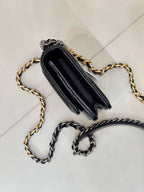 Chanel mini bag back view with dark blue leather, gold and silver chain straps