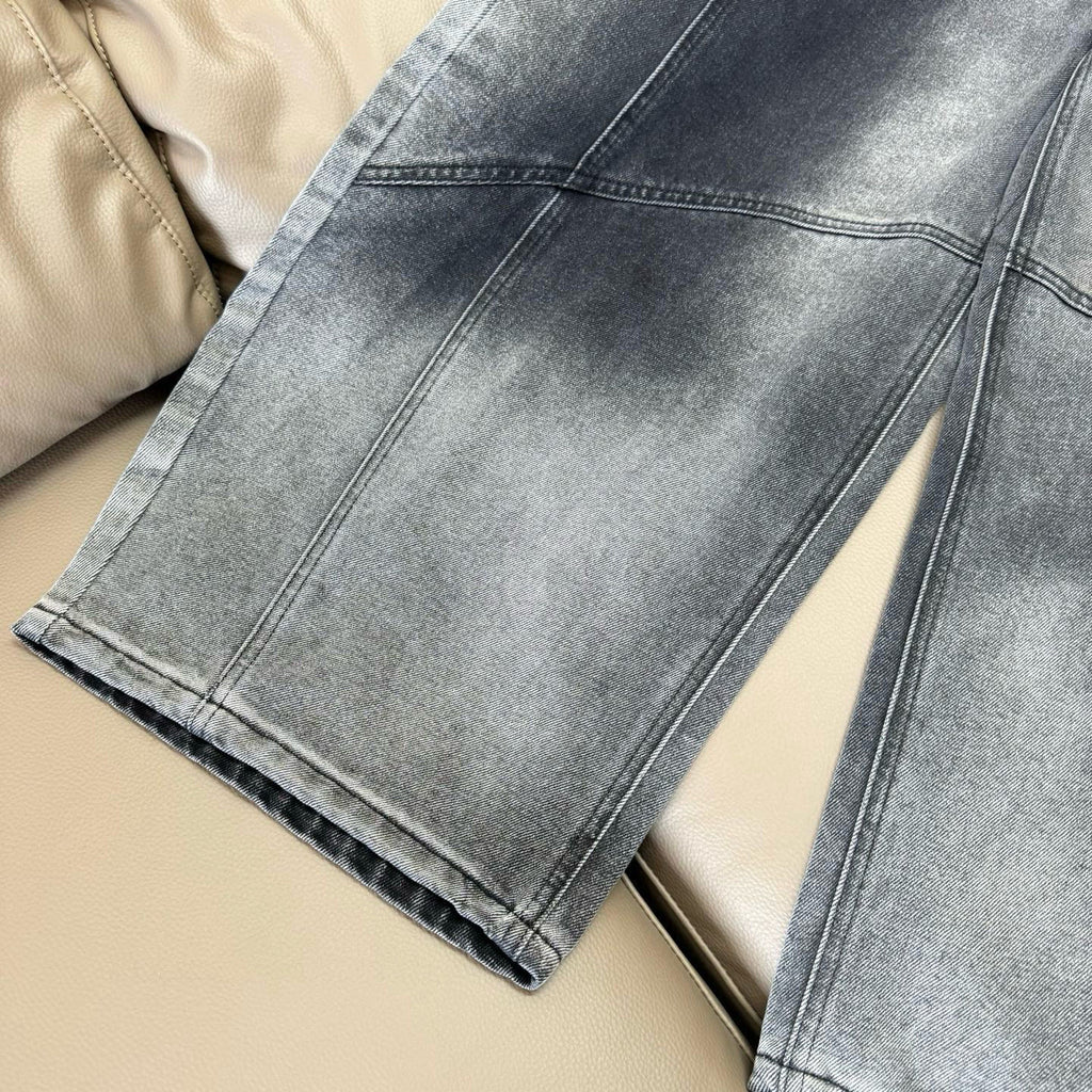 Dark blue denim wide-leg pants showing straight seam lines and folded hem