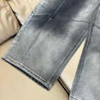 Dark blue denim wide-leg pants showing straight seam lines and folded hem
