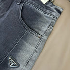 Dark blue denim pants close-up of curved front pocket and zipper detail